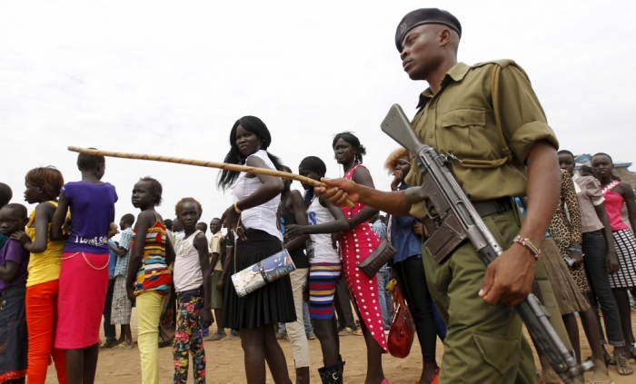 A policeman patrols as refugees from South Sudan queue to attend the celebrations to mark World Refugee Day at the Kakuma refugee camp in Turkana District, northwest of Kenya's capital Nairobi, June 20, 2015.