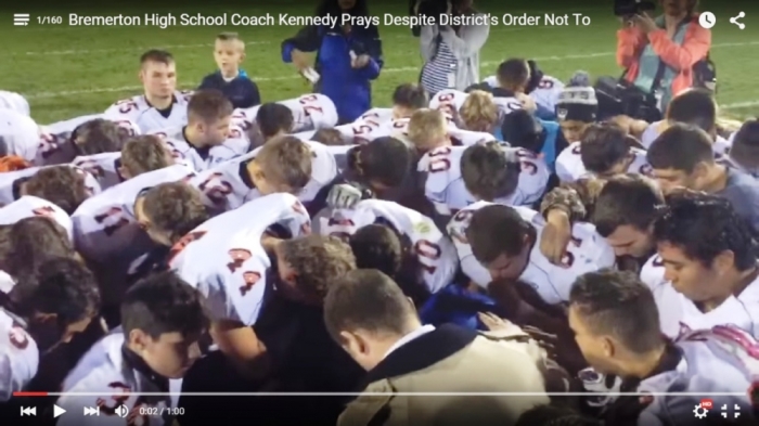 A screengrab from a video report on the Bremerton High School football team coach’s prayer activities.