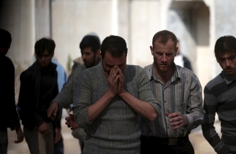 A man reacts as he mourns the death of his relative after missiles were fired by Syrian government forces on a busy marketplace in the Douma neighborhood of Damascus, Syria, October 30, 2015. At least 40 people were killed and about 100 wounded after Syrian government forces fired missiles into a market place in a town near Damascus, a conflict monitor and a local rescue group said on Friday.