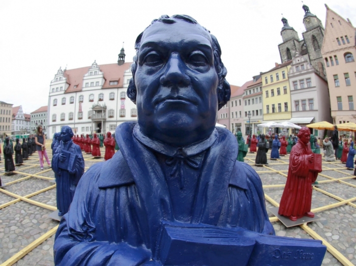 Plastic statuettes of 16th-century Protestant reformer Martin Luther, which are part of the art installation 'Martin Luther - I'm standing here' by German artist Ottmar Hoerl, are pictured in the main square in Wittenberg, eastern Germany, August 11, 2010. The installation of 800 one-metre high figurines, based on a statue of Martin Luther on the town square and intended to replace it while it is being renovated. Hoerl's creation has created some controversy, with some Protestant theologians saying the statuettes, make a mockery of Luther's achievements.