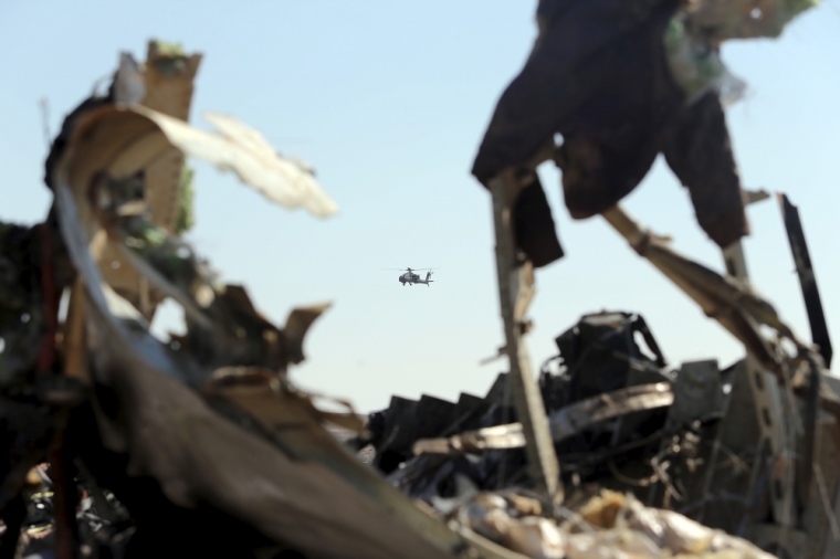 An Egyptian military helicopter flies over debris from a Russian airliner which crashed at the Hassana area in Arish city, north Egypt, November 1, 2015. Russia has grounded Airbus A321 jets flown by the Kogalymavia airline, Interfax news agency reported on Sunday, after one of its fleet crashed in Egypt's Sinai Peninsula, killing all 224 people on board.