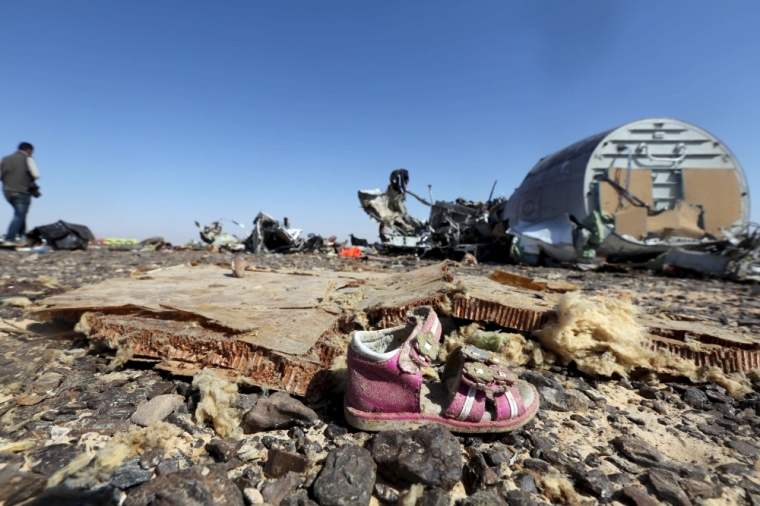A child's shoe is seen in front of debris from a Russian airliner which crashed at the Hassana area in Arish city, north Egypt, November 1, 2015. Russia has grounded Airbus A321 jets flown by the Kogalymavia airline, Interfax news agency reported on Sunday, after one of its fleet crashed in Egypt's Sinai Peninsula, killing all 224 people on board.