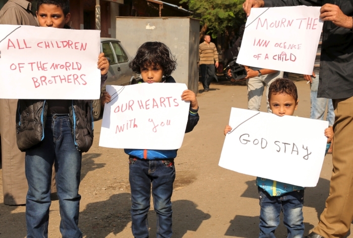 Egyptian children carrying banners in solidarity with Russian children who died in Saturday's plane crash over Sinai, stand in front of a morgue where bodies of the victims lie in Cairo, Egypt November 1, 2015. Russia has grounded Airbus A321 jets flown by the Kogalymavia airline, Interfax news agency reported on Sunday, after one of its fleet crashed in Egypt's Sinai Peninsula, killing all 224 people on board.