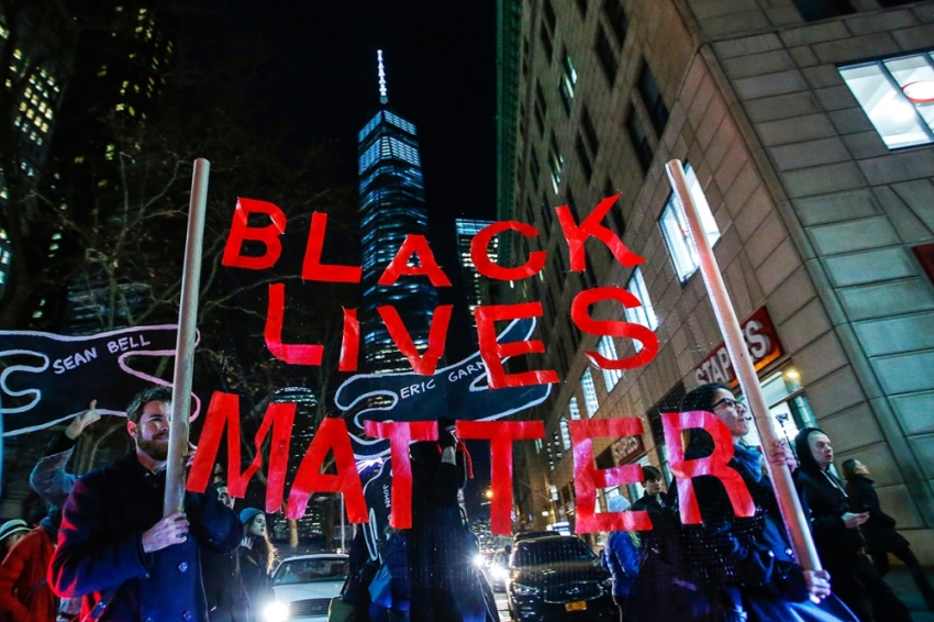 Protesters hoist a sign reading "black lives matter" as they demonstrate in New York City.