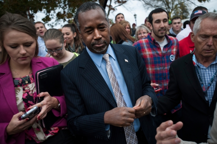 Republican presidential candidate Dr. Ben Carson leaves a breakfast at the Alpha Gamma Roh fraternity at Iowa State University in Ames, Iowa, on October 24, 2015.