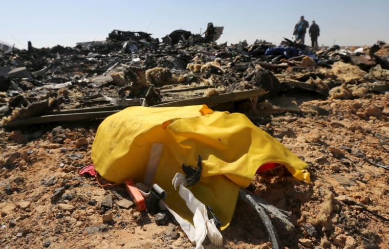 The remains of a Russian airliner are seen as military investigators inspect the crash site in al-Hasanah area in El Arish city, north Egypt, November 1, 2015. Rescue teams scoured the area where the Airbus A321 came down on Saturday, collecting into a pile the dead holidaymakers' belongings that were spread around the main part of the wreckage. At least 163 of the bodies have already been recovered from the jet.