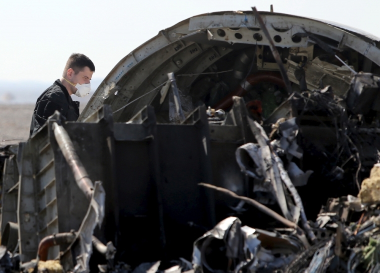 A military investigator from Russia stands near the debris of a Russian airliner at its crash site at the Hassana area in Arish city, north Egypt, November 1, 2015. Russia has grounded Airbus A321 jets flown by the Kogalymavia airline, Interfax news agency reported on Sunday, after one of its fleet crashed in Egypt's Sinai Peninsula, killing all 224 people on board.