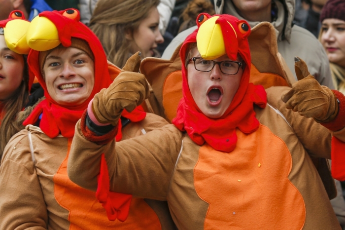 Spectators react as they watch the 88th Annual Macy's Thanksgiving Day Parade in New York, November 27, 2014.