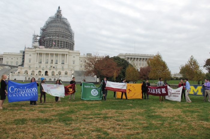 Student from various Catholic and Jesuit schools hold up their school banners in front the U.S. Capitol building in Washington D.C. on November 9, 2015m as part of the National Catholic Social Justice Conference.