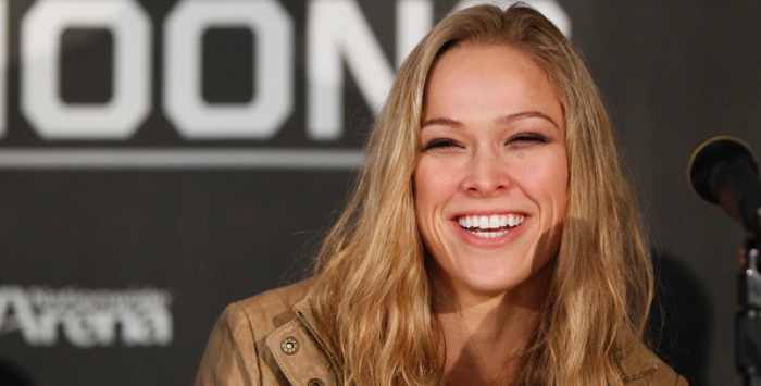 Ronda Rousey smiling at a press conference.