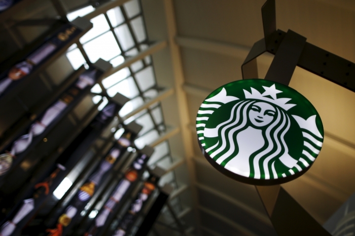 A Starbucks store is seen inside the Tom Bradley terminal at LAX airport in Los Angeles, California, United States, October 27, 2015. Starbucks Corp brewed up another quarter of strong sales and profit growth, but its shares fell more than 3 percent after the richly valued cafe chain's 2016 forecast offered little upside to Wall Street's target. Starbucks said on Thursday global sales at cafes open at least 13 months were up 8 percent in the fourth quarter ended Sept. 27, beating than the 6.9 percent rise expected by analysts polled by research firm Consensus Metrix.