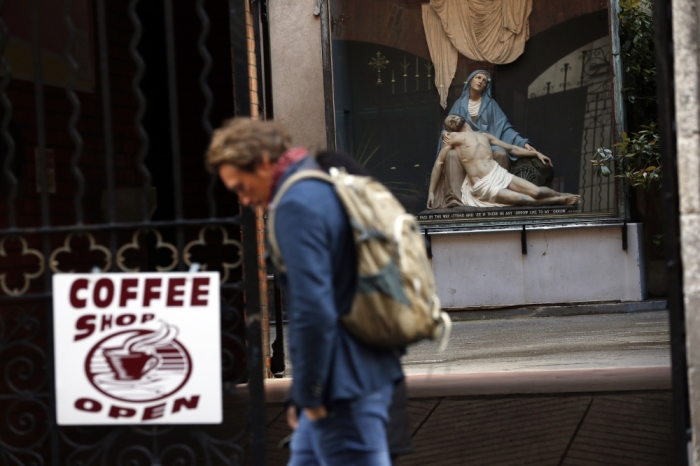 A man walks past a statue of Mary and Jesus in the Grafton street area of Dublin in Ireland, May 19, 2015. Irish voters are set to back the introduction of gay marriage by a margin of as much as two-to-one and become the first country to approve the policy in a national plebiscite, a series of polls have indicated.