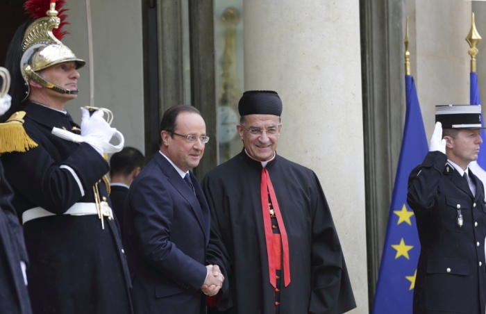French President Francois Hollande (L) greets Cardinal Bechara Boutros Rai of Lebanon at the Elysee Palace in Paris April 9, 2013.