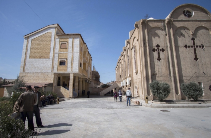 Displaced Assyrians, who fled from the villages around Tel Tamr, sit outside the Assyrian Church in al-Hasaka city, as they wait for news about the Assyrians abductees remaining in Islamic State hands March 9, 2015. Islamic State released 19 Assyrian Christian captives in Syria on March 1 after processing them through a sharia court, a monitoring group which tracks the conflict said. More than 200 Assyrians remain in Islamic State hands, said the British-based Syrian Observatory for Human Rights.