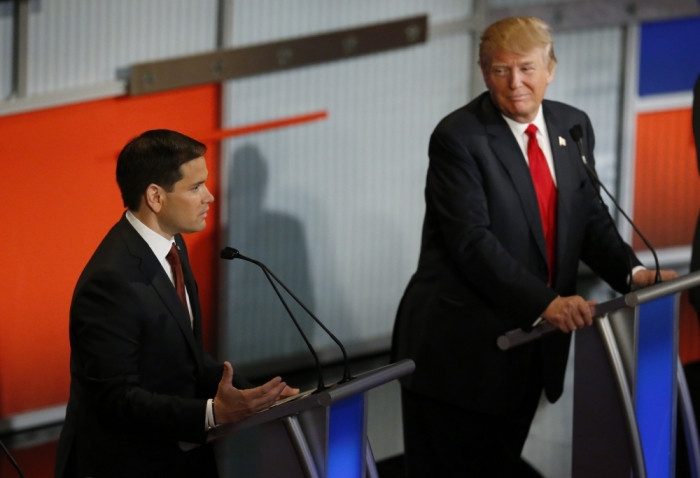 Republican U.S. presidential candidate and U.S. Senator Marco Rubio speaks as businessman Donald Trump (R) listens at the debate held by Fox Business Network for the top 2016 U.S. Republican presidential candidates in Milwaukee, Wisconsin, November 10, 2015.