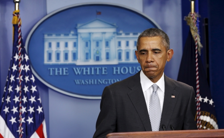 U.S. President Barack Obama pauses while speaking about the shooting attacks in Paris, from the White House in Washington, November 13, 2015.