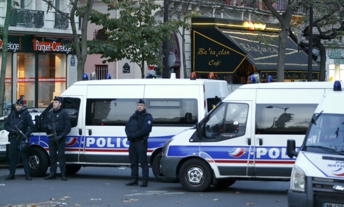 Police vehicles block the street in front of the Bataclan concert hall the morning after a series of deadly attacks in Paris, November 14, 2015.
