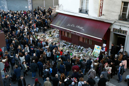 People gather outside La Carillon restaurant, one of the attack sites in Paris, November 15, 2015.