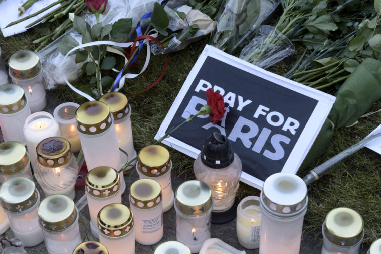 Candles in remembrance of victims of the Paris attack are seen at a memorial site outside French embassy in Helsinki, November 15, 2015.