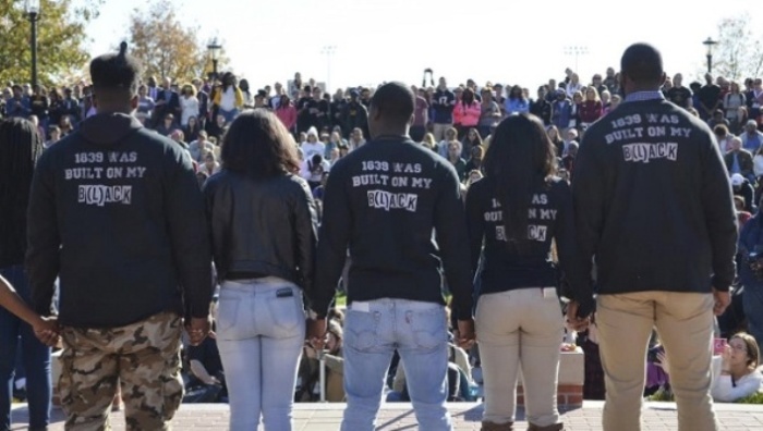 Members of Concerned Student 1950 join hands at a press conference at Traditions Plaza at Carnahan Quad, on the University of Missouri campus in Columbia, Missouri, November 9, 2015.