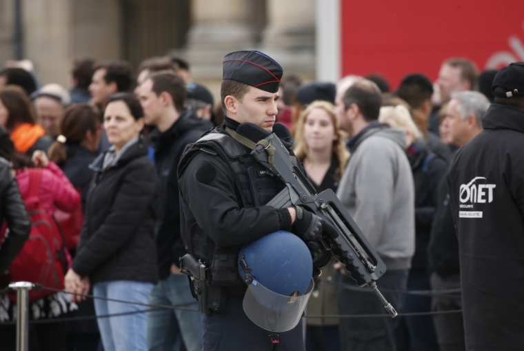 A French gendarme patrols in front of the Louvre Museum Pyramid as it re-opens in Paris, France, November 16, 2015, following the series of deadly attacks on Friday in the French capital.