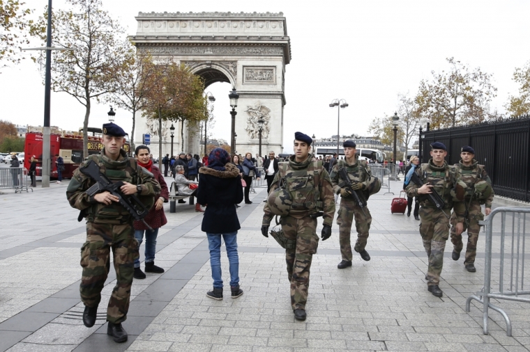 Soldiers patrol in front of the Arc de Triomphe on the Champs Elysees in Paris, France, November 16, 2015, as security increases after last Friday's series of deadly attacks in the French capital.