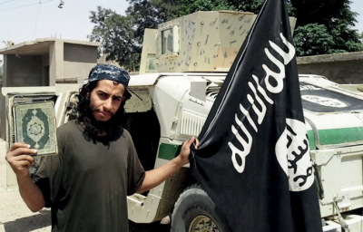 An undated photograph of a man described as Abdelhamid Abaaoud that was published in the Islamic State's online magazine Dabiq and posted on a social media website. A Belgian national currently in Syria and believed to be one of Islamic State's most active operators is suspected of being behind Friday's attacks in Paris, according to a source close to the French investigation. 'He appears to be the brains behind several planned attacks in Europe,' the source told Reuters of Abdelhamid Abaaoud, adding he was investigators' best lead as the person likely behind the killing of at least 129 people in Paris on Friday. According to RTL Radio, Abaaoud is a 27 year old from the Molenbeek suburb of Brussels, home to other members of the militant Islamist cell suspected of having carried out the attacks.