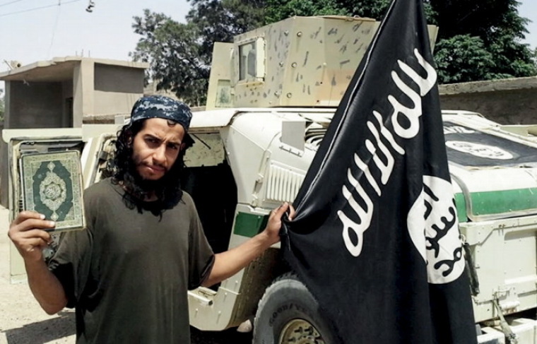 An undated photograph of a man described as Abdelhamid Abaaoud that was published in the Islamic State's online magazine Dabiq and posted on a social media website. A Belgian national currently in Syria and believed to be one of Islamic State's most active operators is suspected of being behind Friday's attacks in Paris, according to a source close to the French investigation. 'He appears to be the brains behind several planned attacks in Europe,' the source told Reuters of Abdelhamid Abaaoud, adding he was investigators' best lead as the person likely behind the killing of at least 129 people in Paris on Friday. According to RTL Radio, Abaaoud is a 27 year old from the Molenbeek suburb of Brussels, home to other members of the militant Islamist cell suspected of having carried out the attacks.