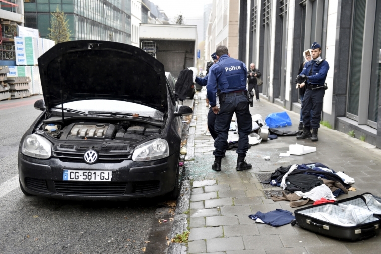 Police officers check a suspected car during an alert in Brussels, Belgium, November 16, 2015, following the deadly attacks in Paris.