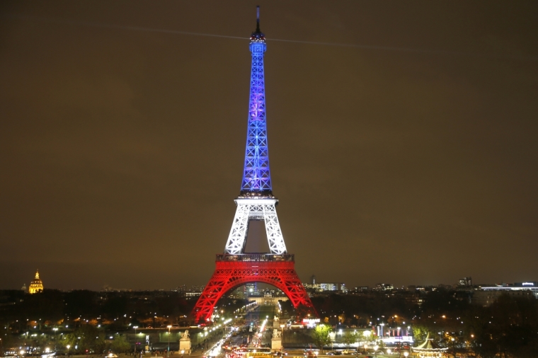 The Eiffel Tower is lit with the blue, white and red colors of the French flag in Paris, France, November 16, 2015, to pay tribute to the victims of a series of deadly attacks on Friday in the French capital.