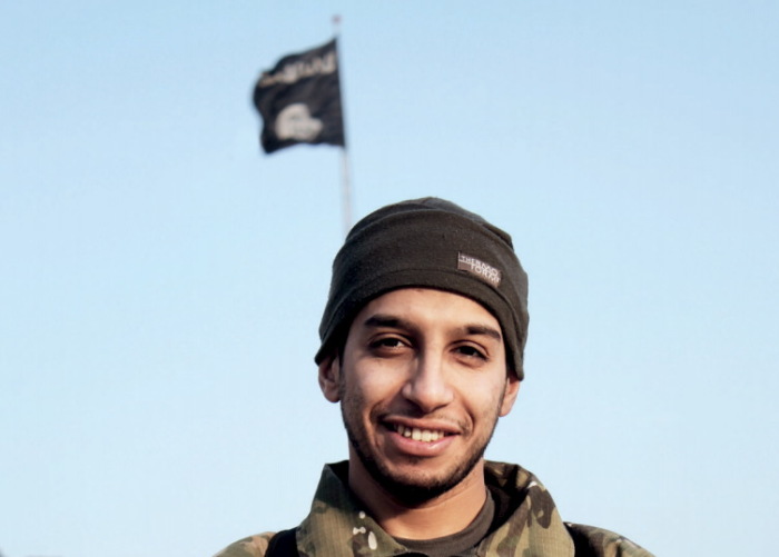 An undated photograph of a man described as Abdelhamid Abaaoud that was published in the Islamic State's online magazine Dabiq and posted on a social media website. A Belgian national currently in Syria and believed to be one of Islamic State's most active operators is suspected of being behind Friday's attacks in Paris, acccording to a source close to the French investigation. 'He appears to be the brains behind several planned attacks in Europe,' the source told Reuters of Abdelhamid Abaaoud, adding he was investigators' best lead as the person likely behind the killing of at least 129 people in Paris on Friday. According to RTL Radio, Abaaoud is a 27 year old from the Molenbeek suburb of Brussels, home to other members of the militant Islamist cell suspected of having carried out the attacks.