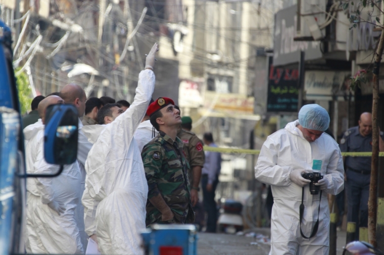 Lebanese army soldiers and forensic inspectors examine the site of the two explosions that occured on Thursday in the southern suburbs of the Lebanese capital Beirut, November 13, 2015. Lebanon observed a national day of mourning on Friday after two suicide bombs the day before killed 43 people in southern Beirut, in an act the United Nations condemned overnight as 'despicable.'
