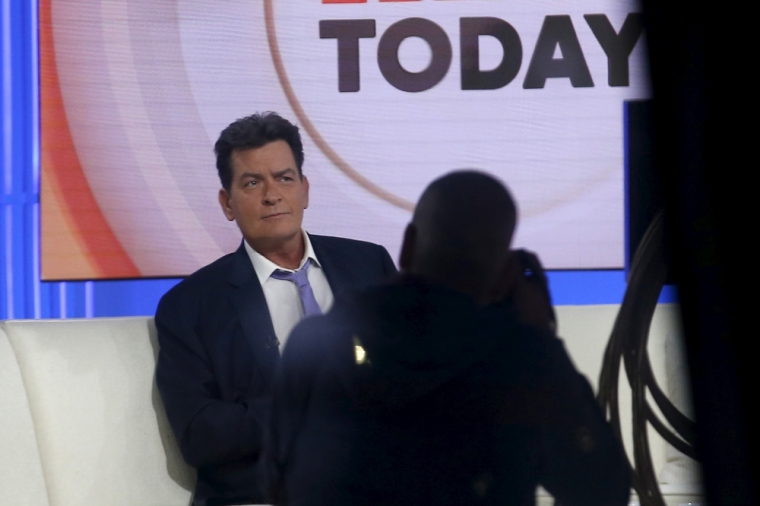 Actor Charlie Sheen is seen through a window as he sits on the set of the NBC 'Today' show prior to being interviewed by host Matt Lauer in the Manhattan borough of New York City, November 17, 2015. The former 'Two and A Half Men' star said on Tuesday he is HIV positive.