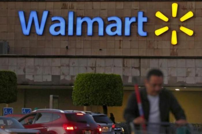 A shopper pushes a cart in front of a Wal-Mart store in Mexico City March 24, 2015.