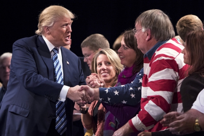 U.S. Republican presidential candidate Donald Trump shakes hand with supporters during a campaign event at Iowa Central Community College in Ft. Dodge, Iowa, November 12, 2015.