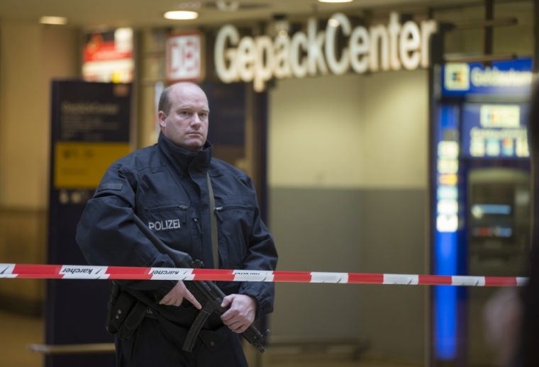 Police cordon off the luggage center at the railway station following a bomb alert, which turned out to be a hoax, in Hanover, Germany November 18, 2015. Germany should not be cowed by the threat of Islamic State violence, the head of the domestic intelligence services said on Wednesday, after an international soccer game was cancelled due to fears of an attack. Germany's soccer match against the Netherlands in Hanover, which Chancellor Angela Merkel had been due to attend, was cancelled on Tuesday evening.