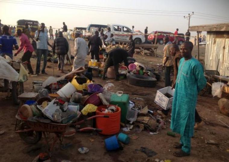 People gather at the scene of a bomb blast at a fruit and vegetable market in the Jimeta area of Yola, Adamawa, Nigeria, on November 18, 2015.