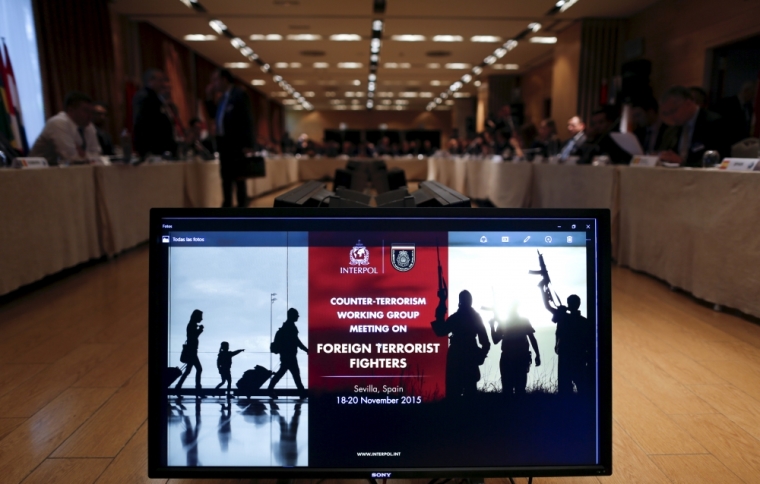 A screen displays information about a counter-terrorism working group meeting on foreign terrorist fighters hosted by Interpol in the Andalusian capital of Seville, southern Spain, November 18, 2015.