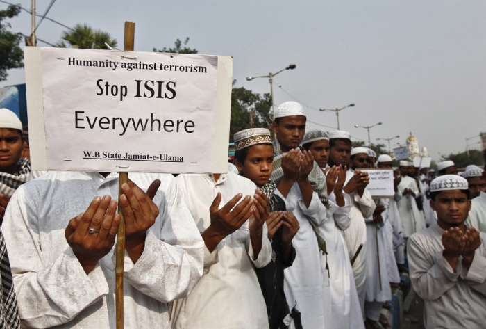 Activists from a Muslim group pray for the victims of the attacks in Paris, in Kolkata, India, November 18, 2015.