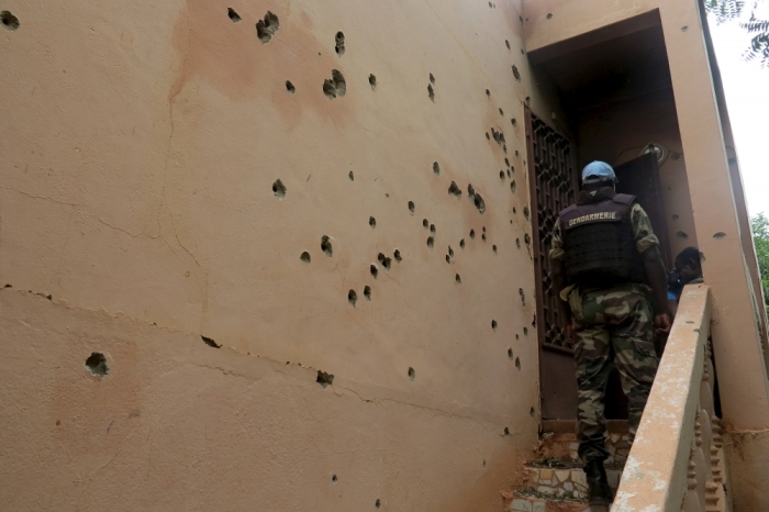 A Malian gendarme climbs stairs at the Byblos hotel, site of a siege over the weekend in which 17 people died in Sevare, Mali, August 11, 2015. Sahara-based Islamist militant group al-Mourabitoun has claimed responsibility for the siege in central Mali, Qatari-based television network Al Jazeera reported on Monday. There was no independent confirmation from the group, which is linked to al Qaeda and has been behind several attacks against Western interests in the Sahel region.