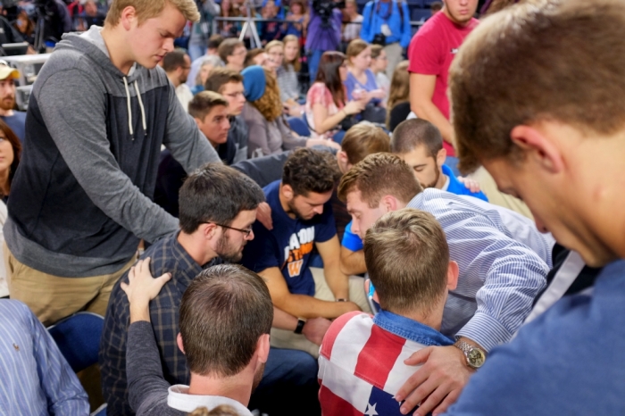 Colin Ragsdale (standing L) prays with friends during a worship service before U.S. Democratic presidential candidate Sen. Bernie Sanders (I-VT) delivers an address to Liberty University students in Lynchburg, Virginia, September 14, 2015.