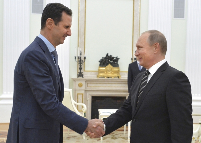 Russian President Vladimir Putin (R) shakes hands with Syrian President Bashar al-Assad during a meeting at the Kremlin in Moscow, Russia, October 20, 2015. Assad flew to Moscow on Tuesday evening to personally thank Putin for his military support, in a surprise visit that underlined how Russia has become a major player in the Middle East. Picture taken October 20, 2015.