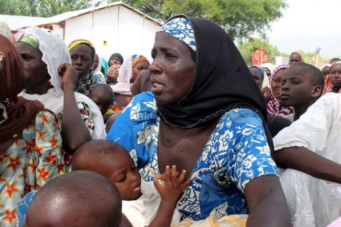 A woman who was rescued after being held captive by Boko Haram, attends to her baby at an internally displaced person's camp near Mubi, northeast Nigeria October 29, 2015. Nigeria's armed forces on Wednesday said it had rescued 338 people held captive by Boko Haram and raided a number of the Islamist militant group's camps on the edge of its stronghold in the northeast's Sambisa forest.