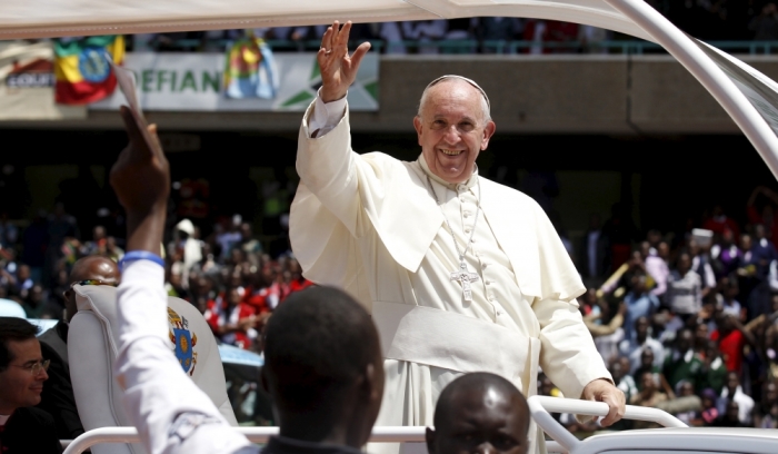 Pope Francis (C) waves to faithful as he leaves after a meeting with the Kenyan youth at the Kasarani stadium in Kenya's capital Nairobi, November 27, 2015.