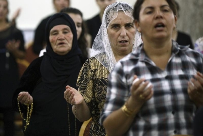 Iraqi Christians fleeing the violence in the Iraqi city of Mosul, pray at the Mar Afram church at the town of Qaraqush in the province of Nineveh, July 19, 2014.