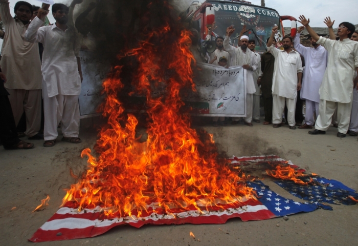Shiite Muslim supporters of the Imamia Student Organization shout slogans as they burn a U.S. flag during an anti-American demonstration in Peshawar, Pakistan, September 14, 2012. Some 40 protesters gathered to take part in the protest to condemn a film being produced in the U.S. that insulted the Islmaic prophet Muhammad.