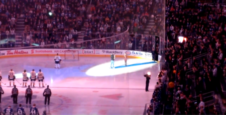 Canadian audience sings United States' national anthem after technical difficulties interfere with a singer's rendition.