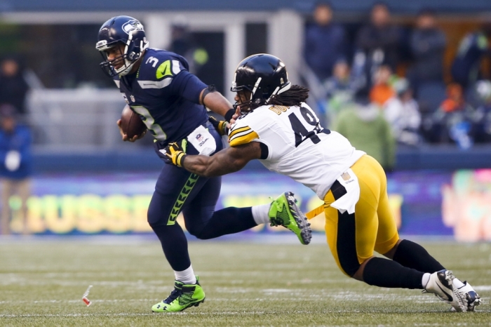 Seattle Seahawks quarterback Russell Wilson (3) escapes a potential sack by Pittsburgh Steelers linebacker Bud Dupree (48) during the fourth quarter at CenturyLink Field, Seattle, Washington, November 29, 2015. Seattle defeated Pittsburgh, 39-30.