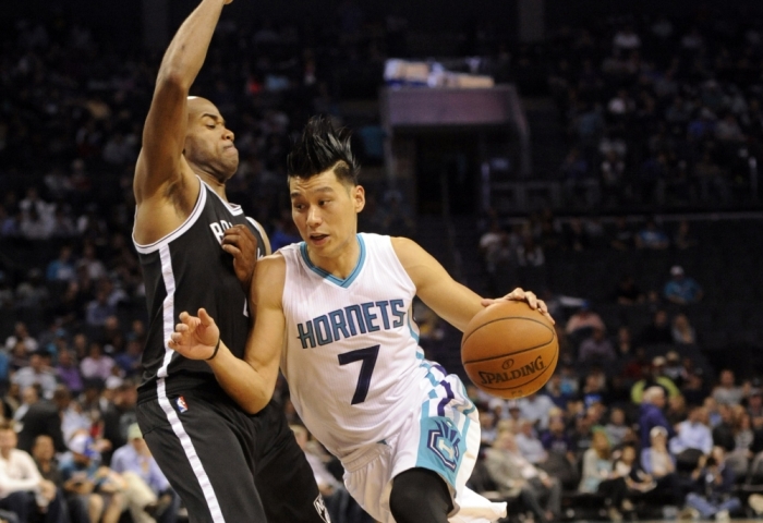 Nov 18, 2015; Charlotte, NC, USA; Charlotte Hornets guard Jeremy Lin (7) drives past Brooklyn Nets guard Jarrett Jack (2) during the first half of the game at Time Warner Cable Arena.