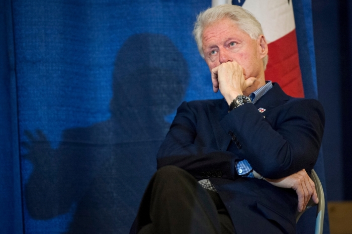 Former U.S. President Bill Clinton listens to his wife, Democratic U.S. presidential candidate Hillary Clinton speak at the Central Iowa Democrats Fall Barbecue in Ames, Iowa November 15, 2015.